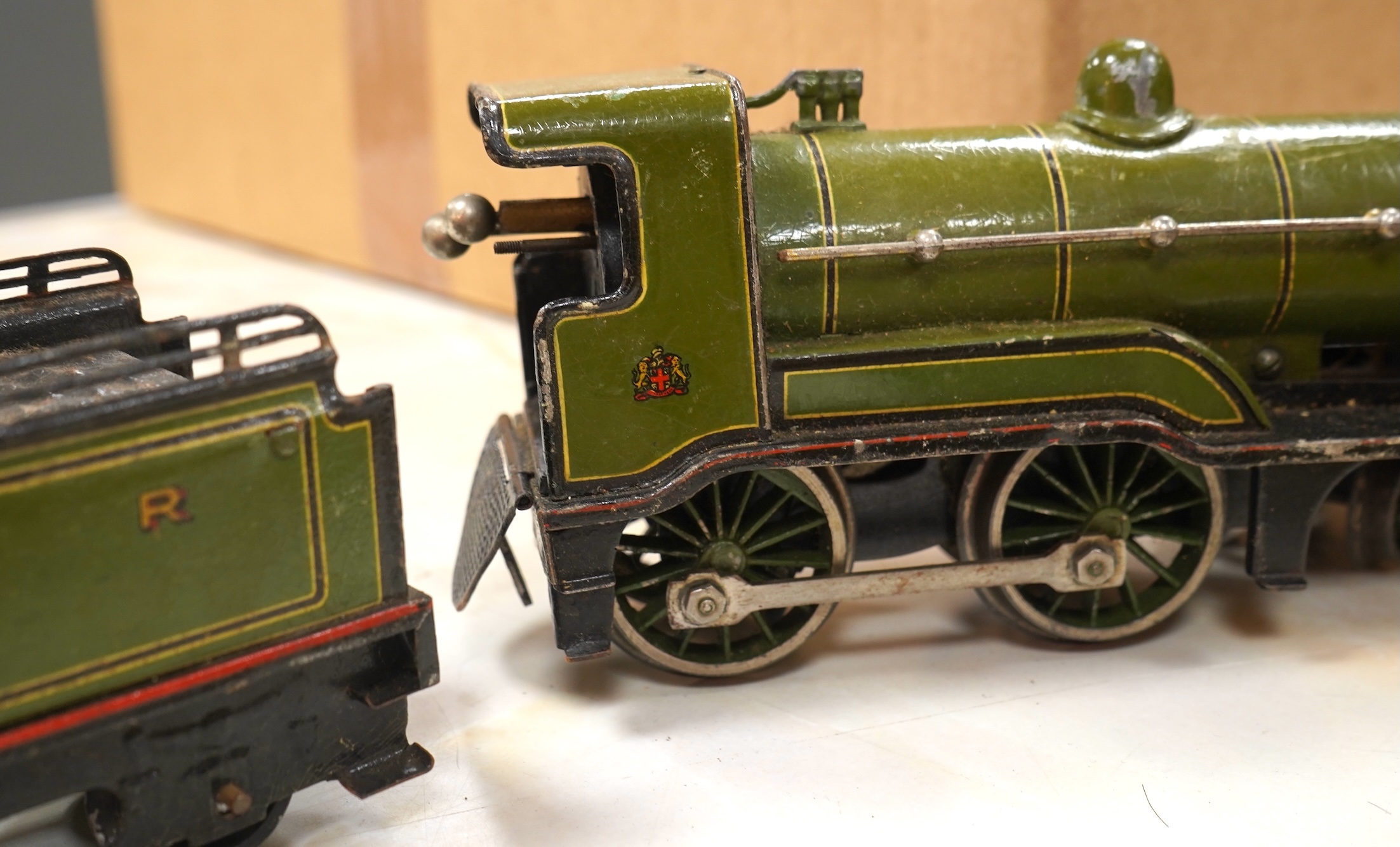 A Bing for Bassett Lowke 0 gauge tinplate clockwork LNER Ivatt 4-4-0 tender locomotive, 4390, together with an early Hornby clockwork 0-4-0, 2710, in GNR green livery with Meccano Ltd roundels to locomotive splasher and